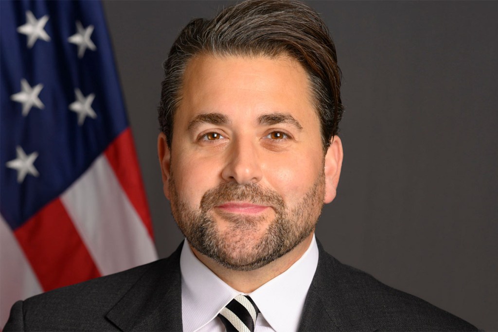 Nick Adams' public comments go against the vision of tourism as a way to promote cross-cultural understanding — an awkward fit for a job meant to promote the U.S. abroad.